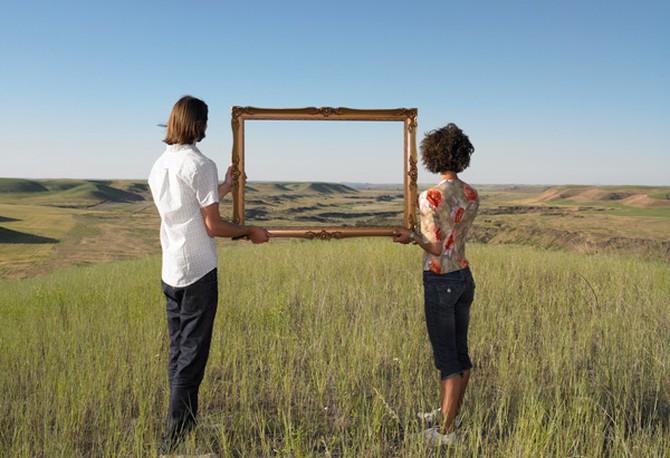 Couple holding a picture frame