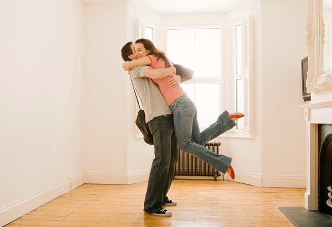 Couple hugging in house
