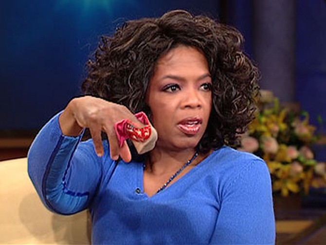 Oprah holding Chinese footbinding slipper