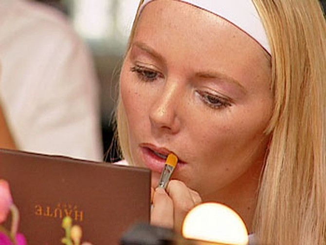 Christie applying lipstick