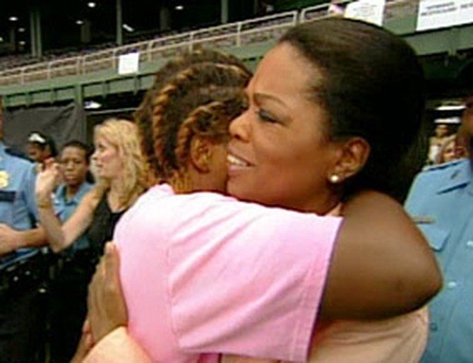 Oprah comforts a Katrina survivor.