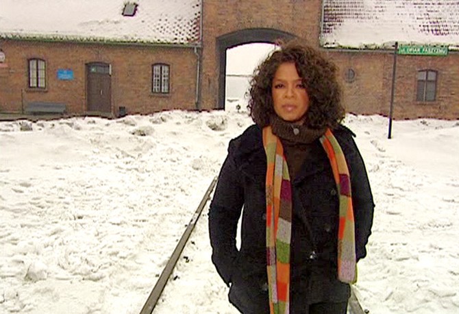 Oprah at the entrance to Auschwitz
