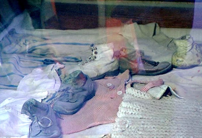 A display case full of Auschwitz prisoners' baby clothes