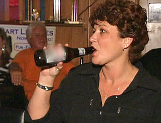Lori drinks at a bar