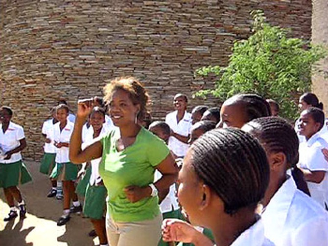 The students at the leadership academy serenade Oprah.