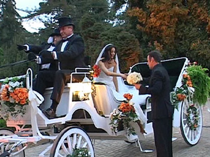 Colin helps Urania out of her horse-drawn carriage.