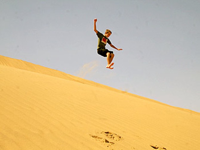 Dax jumps a sand dune in Namibia.