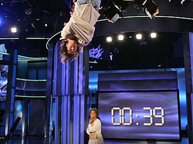 Criss Angel dangles above the audience as he tries to break Houdini's record.