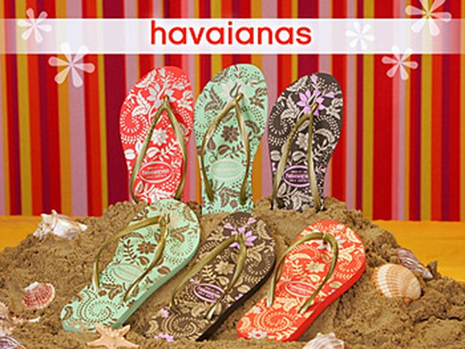 A staff member models Havaianas flip-flops.