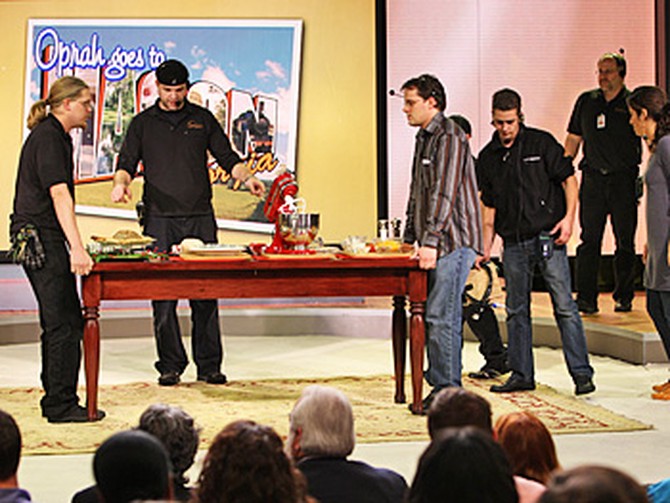 Employees set the stage for a segment with Paula Deen.