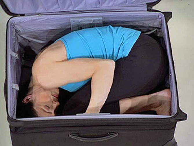 Contortionist Leslie Tipton folds herself into a suitcase.