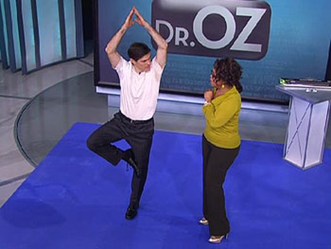 Dr. Oz demonstrates yoga.