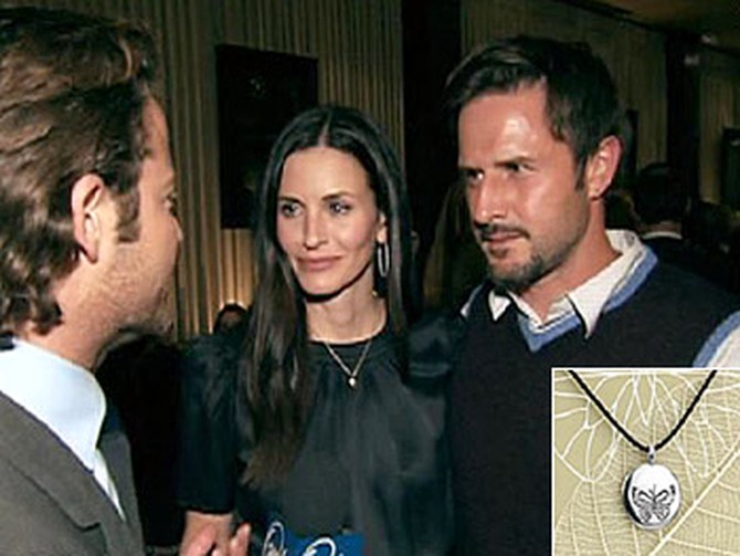 David Arquette and Courteney Cox Arquette show their EB necklace.