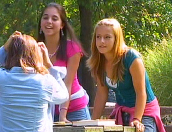 Three mean girls torment another teenage girl.