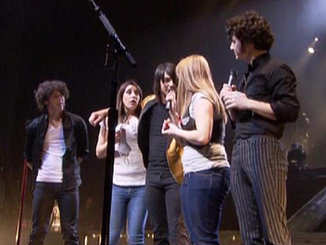 The Jonas Brothers surprise Alessandra and Kim onstage.