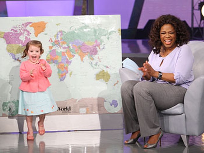 Lilly shows Oprah her geography skills.