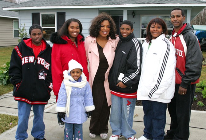 Oprah in front of a Katrina home