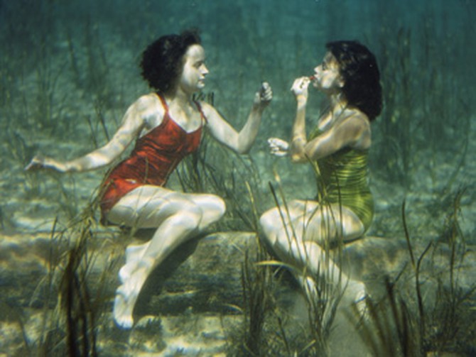 Applying lipstick underwater in the 1940s.